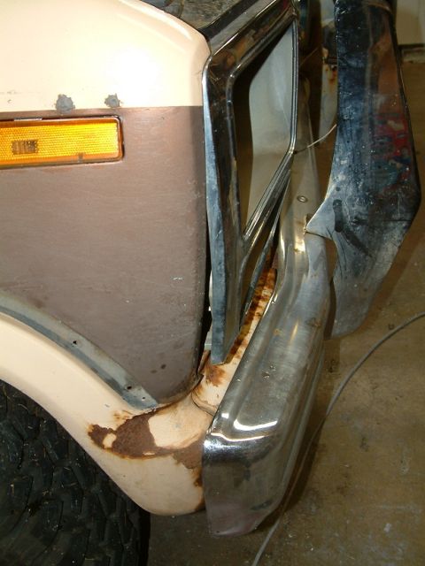 1983 Ford Bronco - The front corner of a 1983 Ford Bronco shows its chrome bumper and amber turn signal, with visible rust.