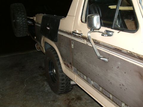 1983 Ford Bronco - Rear passenger side of a 1983 Ford Bronco with a spare tire mounted externally.