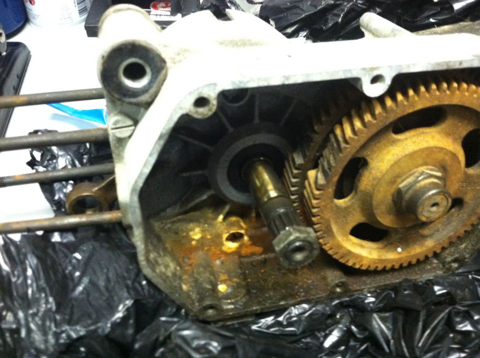Close-up of a rusty motorcycle engine case with gears visible