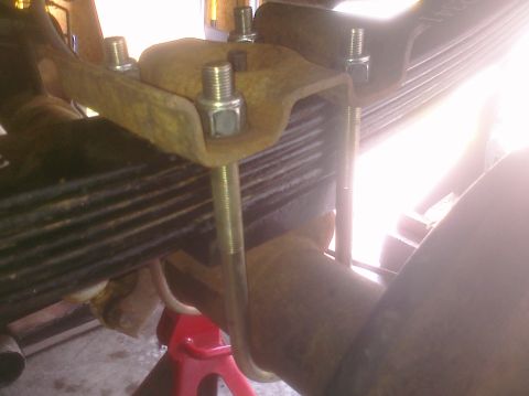 1995 Ford Bronco - Close-up of a vehicle's rear suspension leaf spring assembly, showing rust and hardware.