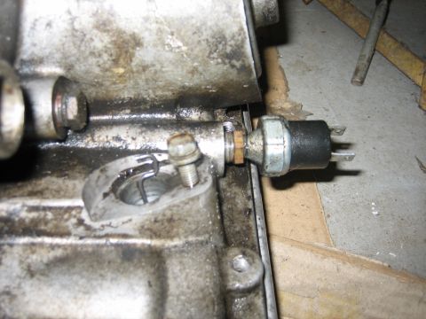 1979 Chevrolet C/K Pickup - This is a close-up view of an oil pressure sensor installed on an engine block, showing mechanical components.