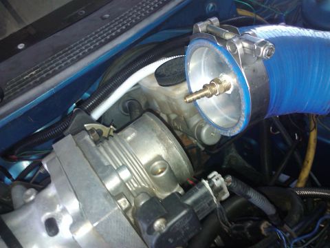 1995 Ford Probe - Close-up view of engine bay components, including a blue hose and throttle body.