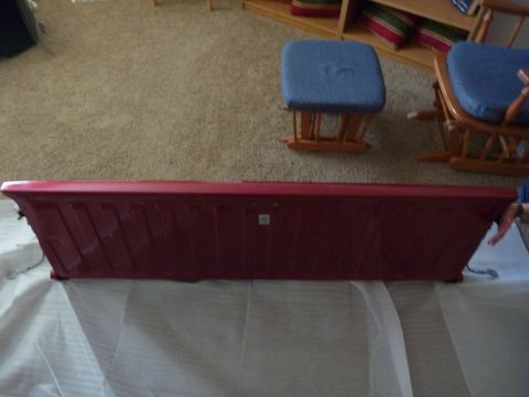 1997 Dodge 2500 - A red pickup truck tailgate is shown indoors, resting on a white sheet.