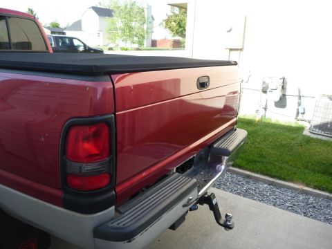 1997 Dodge 2500 - Rear view of a red 1997 Dodge 2500 pickup truck, a black tonneau cover and a trailer hitch.