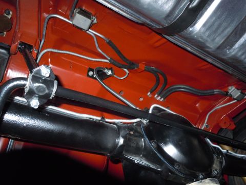 1972 Chevrolet Camaro - The undercarriage of a vehicle shows brake lines, fuel lines, and the rear axle assembly.