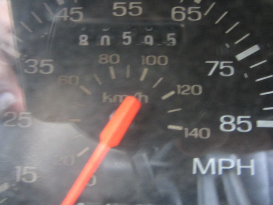 close-up of a car's speedometer and odometer showing 80054.5 miles