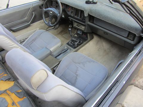 1985 Ford Mustang - Interior view of a 1985 Ford Mustang, front seats and dashboard details.