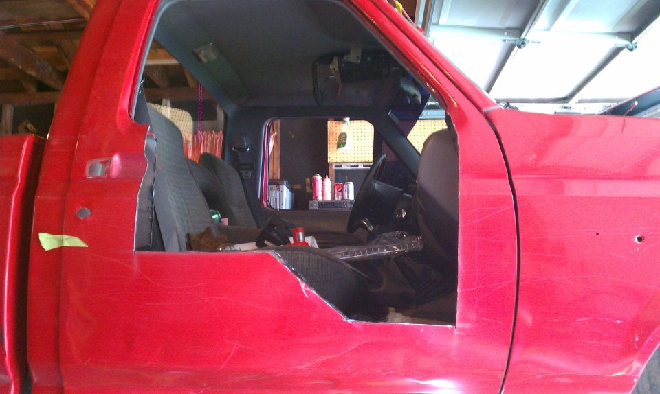 Red truck cab interior with cut-out door panel. 1994 Ford F-250