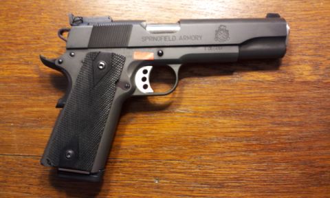 2007 Nissan Titan - Springfield Armory pistol with checkered grip and skeletonized trigger is shown on a wooden table.
