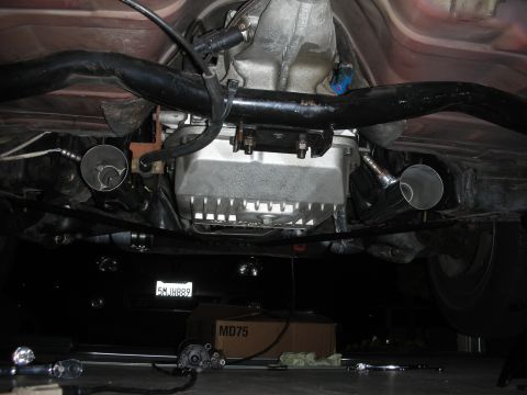 1992 Ford Crown Victoria - The underside of a vehicle is visible, including the transmission and exhaust system, with a license plate in the background.