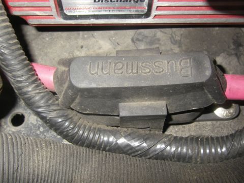 1990 Ford Bronco - A close-up view of a vehicle's electrical system, focusing on a fuse holder and wiring.