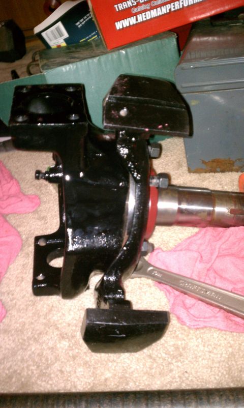 1990 Ford Bronco - A black suspension component, possibly for a truck or SUV, is shown with a wrench. The registry claims it is a 1990 Ford Bronco part.