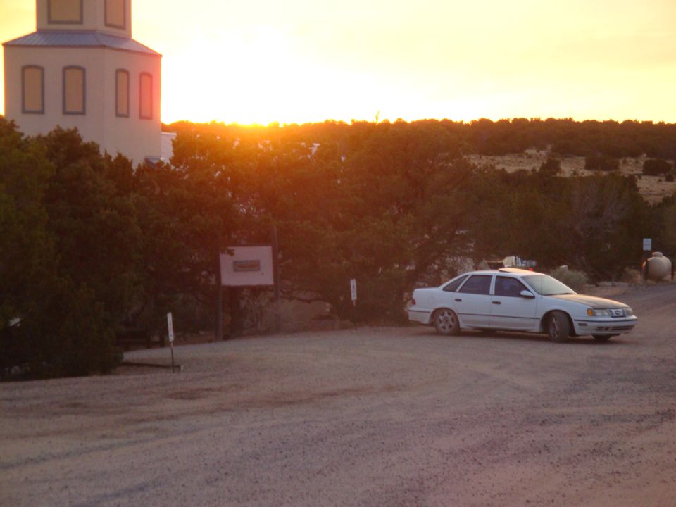 White 1990 Ford Taurus sedan parked at sunset