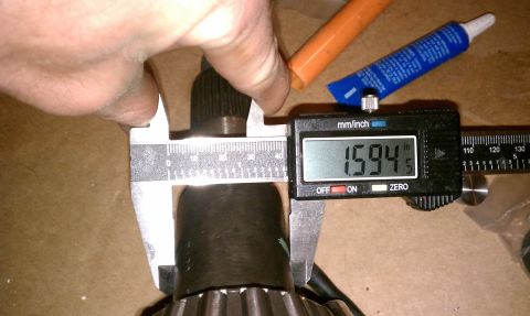 1990 Ford Bronco - Digital calipers are used to measure the diameter of a splined shaft, with a measurement of 1.594 inches displayed.