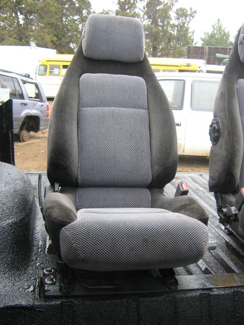 1978 Ford Bronco - A gray patterned car seat with a headrest is shown, with other vehicles visible in the background.