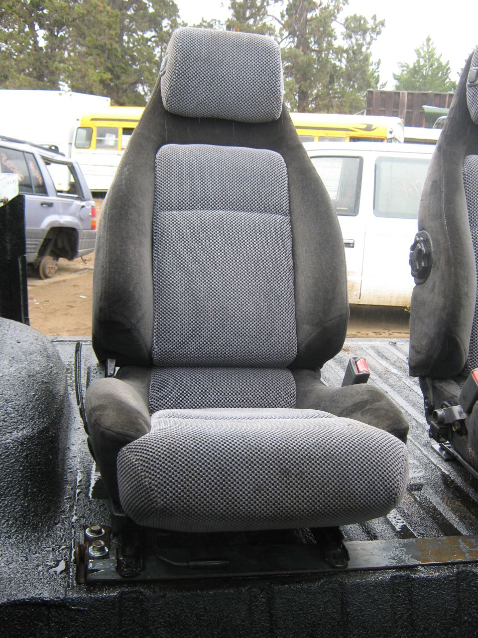 Gray patterned car seat with headrest, seen from the side
