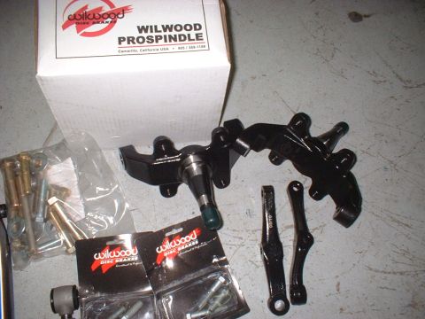 1969 Ford Torino - Wilwood ProSpindle brake parts kit laid out on a concrete surface.