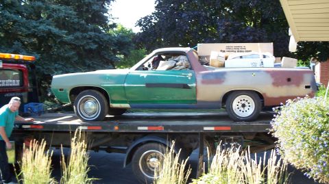 1971 Ford Ranchero - A Ford Ranchero, in need of some bodywork, is being transported on a tow truck.