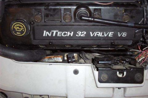 1997 Ford Taurus - Close-up of an InTech 32 Valve V8 engine cover, showing the oil cap and wiring.
