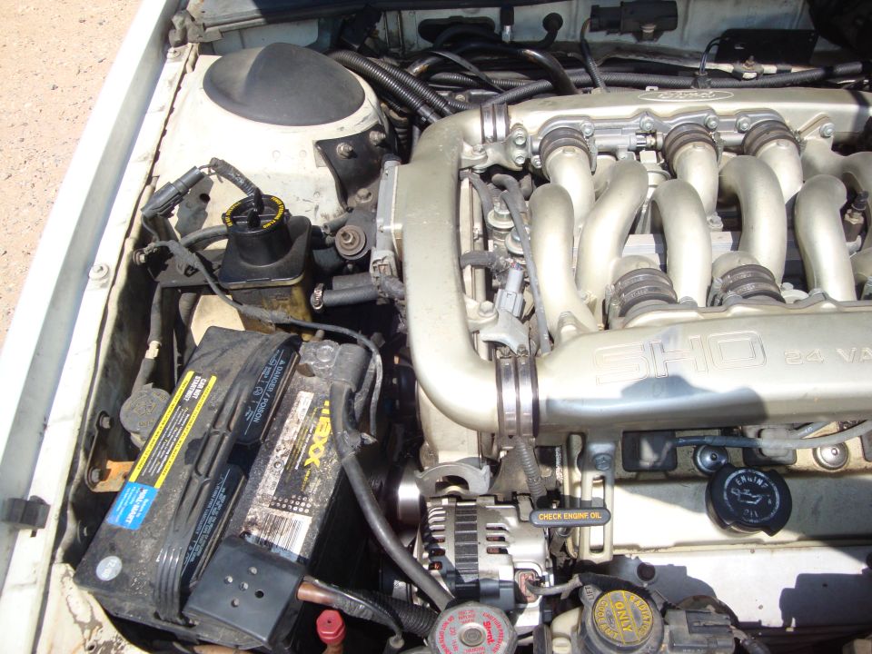 Ford SHO 24-valve V6 engine bay with cast intake manifold, battery and alternator