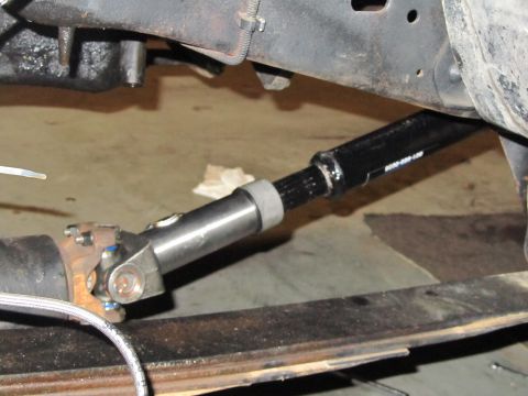 1984 Ford Bronco - Close-up view of a driveshaft and U-joint assembly, showing part number 'NEAP-CO-LLP'.