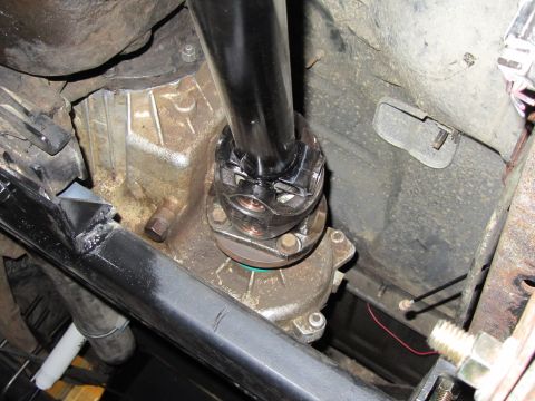 1984 Ford Bronco - Close-up of the vehicle's drivetrain components, showing the driveshaft and transfer case assembly.