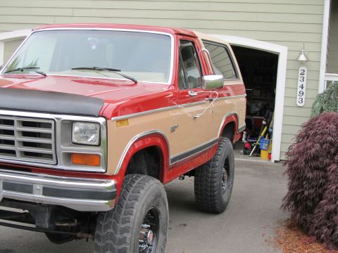 1984 Ford Bronco - This two-tone Ford Bronco features a lifted suspension and large off-road tires, suggesting it is from the early 1980s.