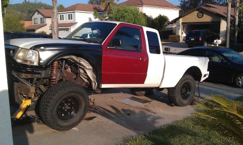 1992 Ford Ranger - This truck features a patchwork of colors on its body panels and a partially disassembled front end, indicating it is undergoing modificati…