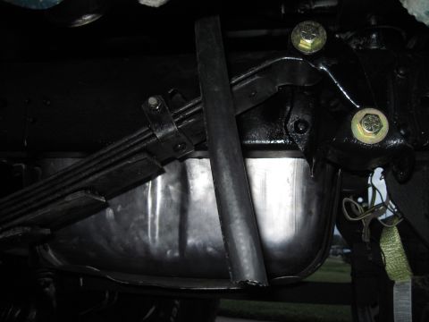 1979 Ford Bronco - Close-up view of the undercarriage components, including leaf springs and a shiny metal pan.