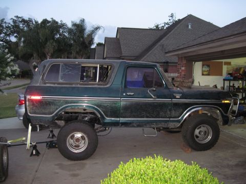 1979 Ford Bronco - This 1979 Ford Bronco is shown in a side profile, lifted on jacks in a driveway.