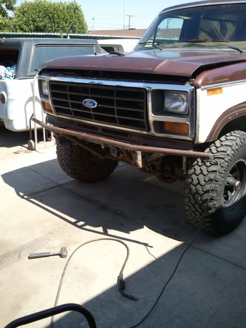 1982 Ford Bronco - This Ford F-Series truck features a custom bumper and off-road tires, with another vehicle visible in the background.
