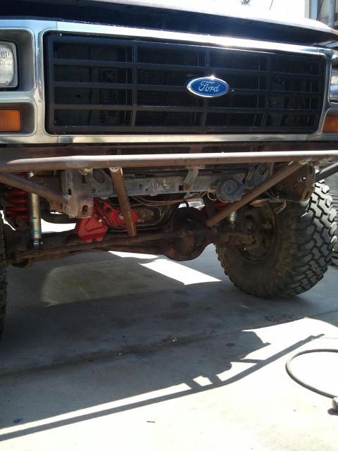 1982 Ford Bronco - This modified 1980s Ford Bronco features a custom bumper and exposed suspension components.