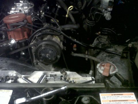 1994 Ford F-150 - Tools laid out in the engine bay, ready for work on the engine components.