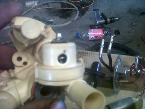 1994 Ford F-150 - A close-up view of a fuel pump assembly, likely for a vehicle, with various hoses and connectors visible.