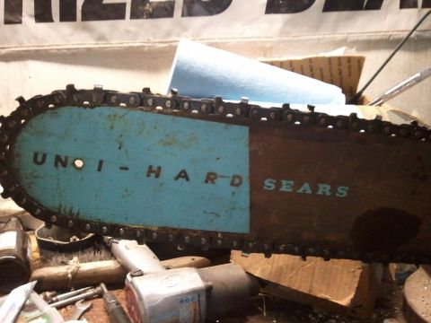 1985 Ford F-150 - Close-up of a chainsaw bar with visible text and chain.