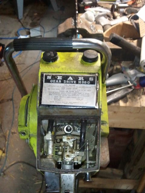 1985 Ford F-150 - A Sears Gear Drive H58G chainsaw is shown with its engine cover removed, revealing internal parts.