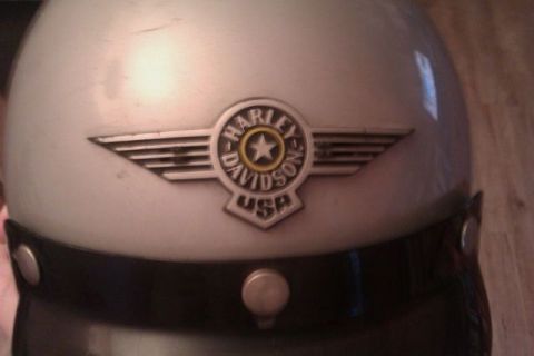 1991 Ford LTD Crown Victoria - A Harley-Davidson helmet is shown up close, displaying its iconic winged emblem.