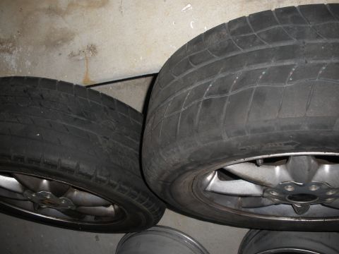 1998 Ford Contour - Close-up view of two tires and their rims, likely stored indoors.