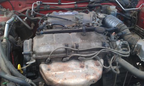 1991 Ford Festiva - Close-up view of a Mazda 16-valve engine, showing various components and wiring.