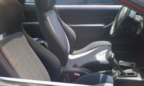 1991 Ford Festiva - The interior of a car is visible, focusing on the seats and the driver's area.