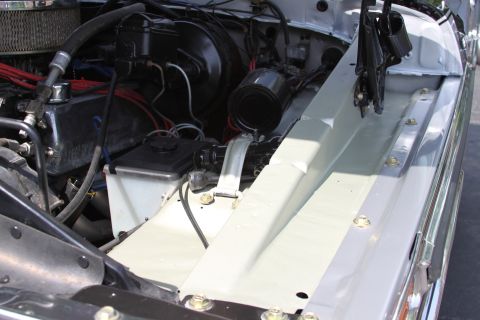 1979 Ford Bronco - Close-up view of the engine compartment, revealing various mechanical parts and wiring harnesses.