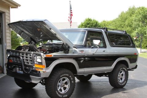 1979 Ford Bronco - This two-tone 1979 Ford Bronco is shown with its hood raised, revealing the engine bay.