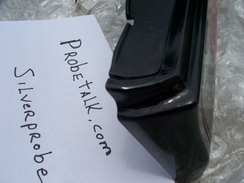 1994 Ford Probe - A black car part is shown next to a piece of paper with handwritten text, including "ProbeTalk.com" and "Silverprobe".