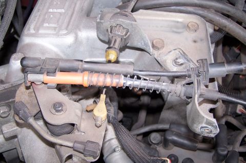 1990 Ford Bronco - Throttle linkage and cables are visible in this engine compartment detail shot.