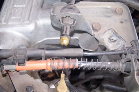 1990 Ford Bronco - This photo shows a close-up view of a vehicle's throttle cable assembly, including various cables and springs.