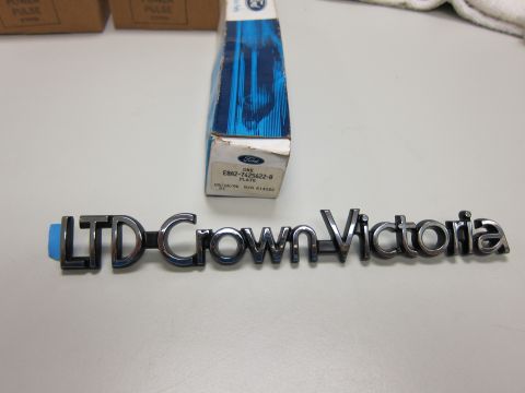 1991 Ford LTD Crown Victoria - Emblem reads LTD Crown Victoria. Part number and date visible on box.