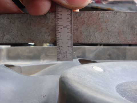 1989 Ford Bronco - Using a ruler to measure a plastic component, likely for automotive repair or modification.