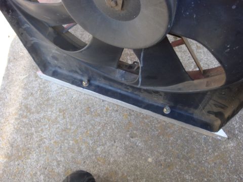 1989 Ford Bronco - Radiator fan shroud with visible bolts and metal reinforcement.