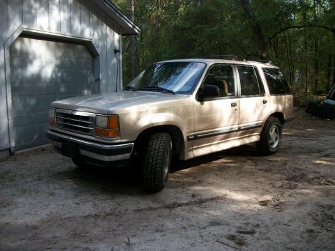 1994 Ford Explorer - This 1994 Ford Explorer is parked in a dirt driveway next to a garage.