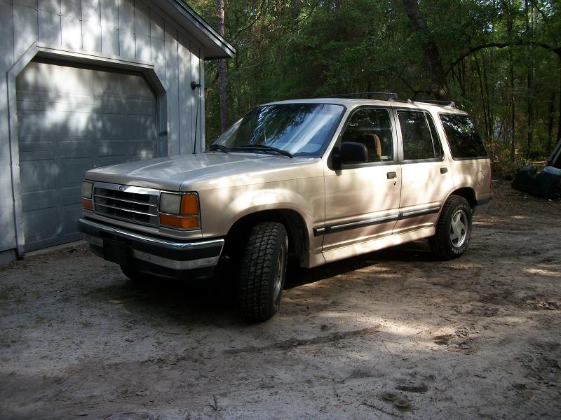 Tan 1994 Ford Explorer parked in front of a garage